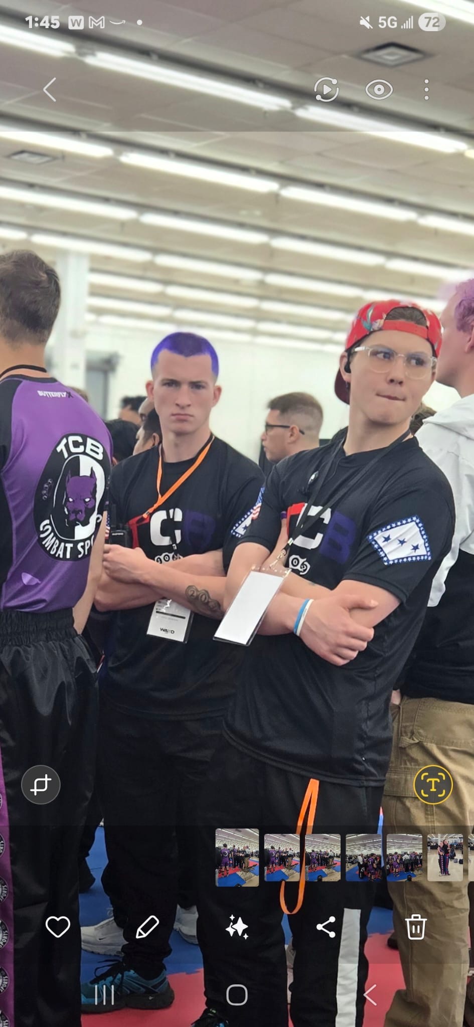 Close-up of two TCB fighters with arms crossed and tournament credentials around their necks at the 2026 WAKO USA Nationals