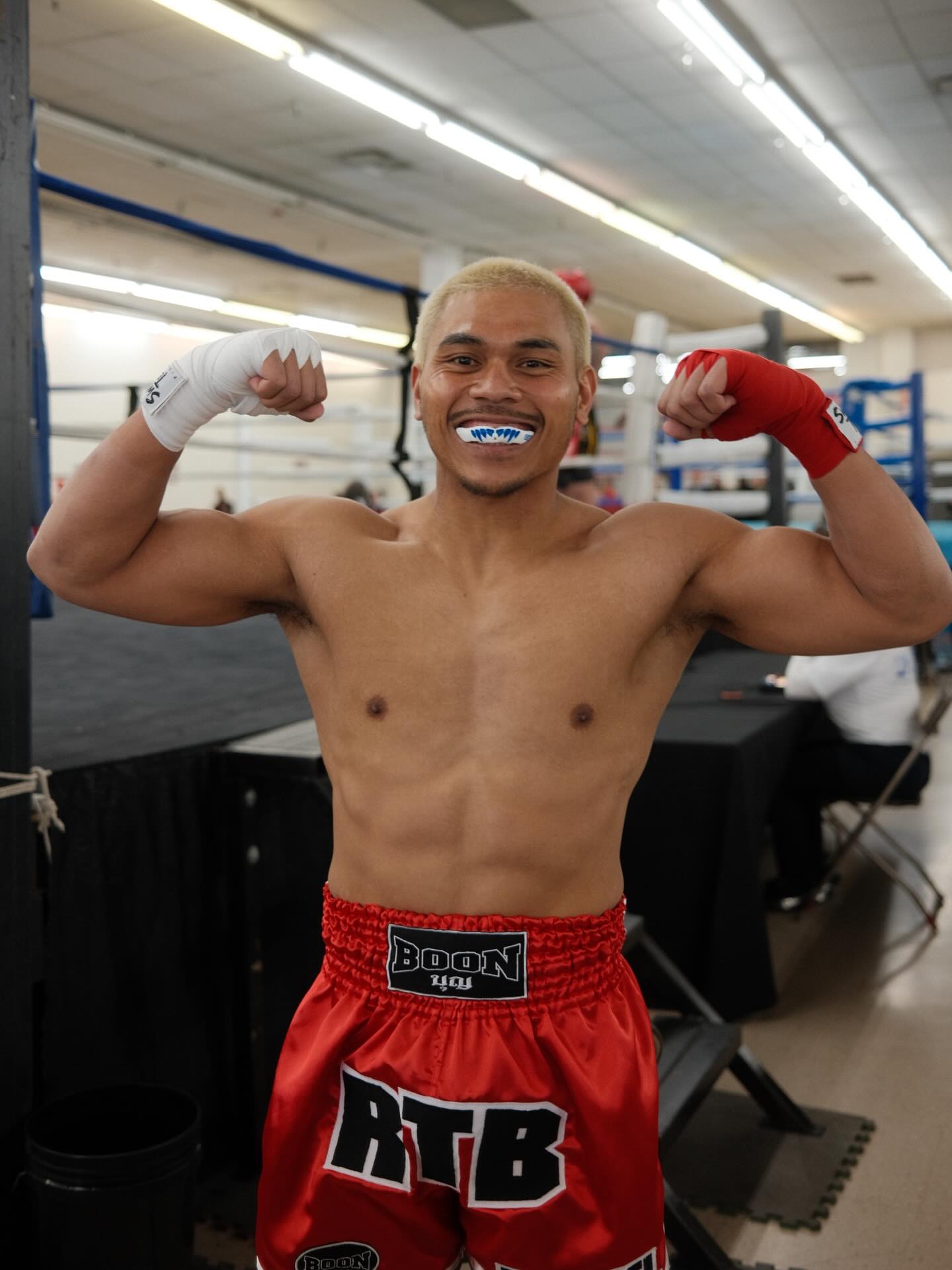 TCB fighter Ryan Manuel flexing in red Boon shorts after his bout at the 2026 WAKO USA Nationals