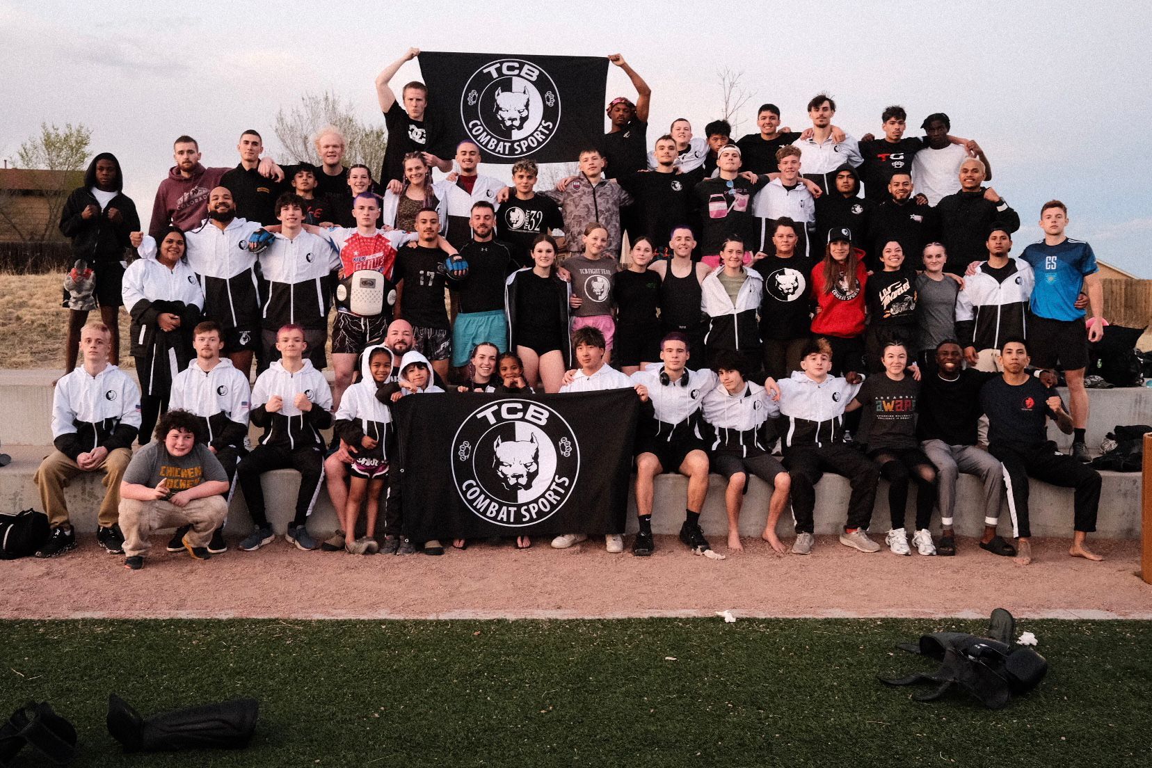 The full TCB Combat Sports team holding the pit bull flag before flying out to Colorado Springs